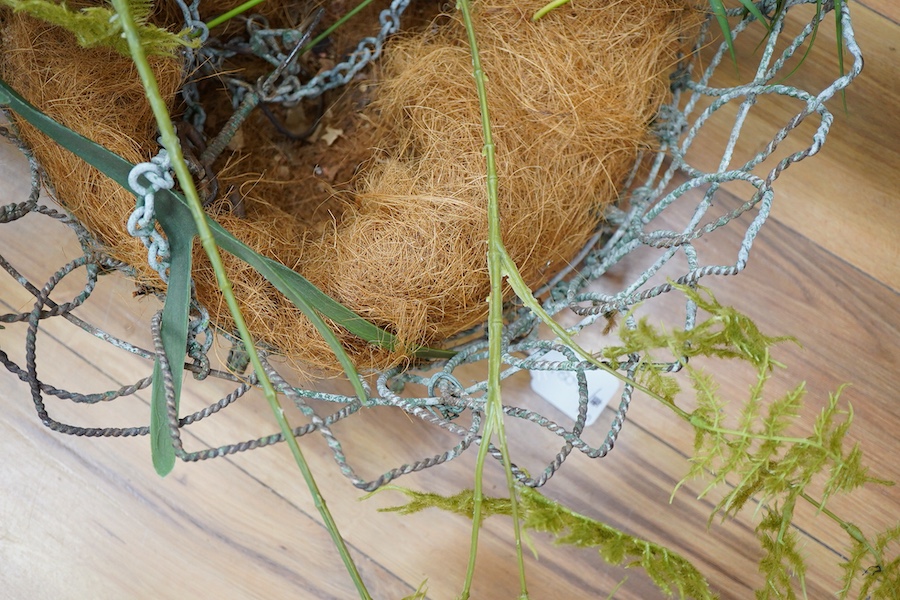 A large wire work hanging basket and decorative faux foliage, 50cm wide